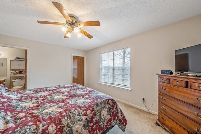 bedroom with ceiling fan, baseboards, a textured ceiling, and light colored carpet