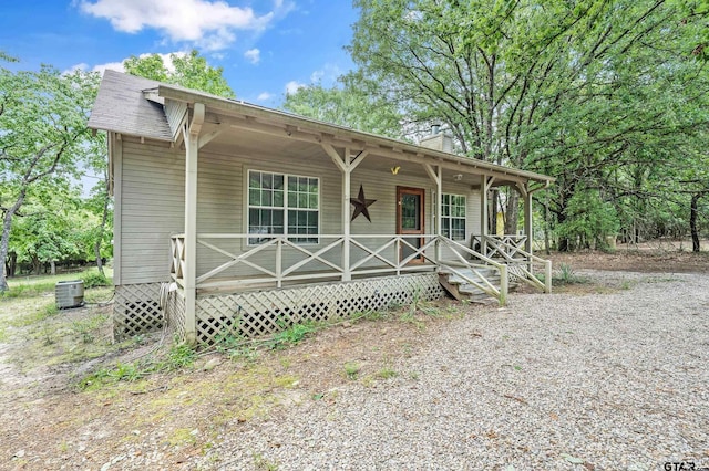 207 Pagosa Ln, Holly Lake Ranch, TX 75765 - view of front of property featuring central AC unit, a porch, and a chimney
