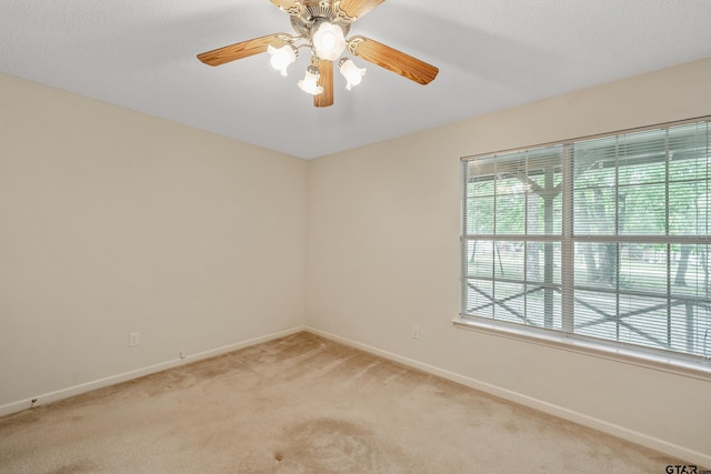 207 Pagosa Ln, Holly Lake Ranch, TX 75765 - spare room featuring light carpet, baseboards, and ceiling fan