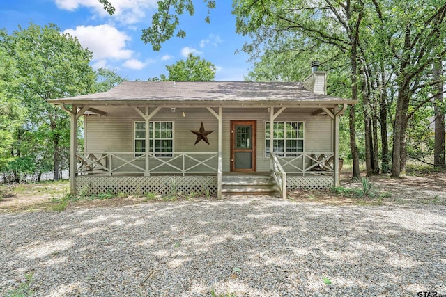 207 Pagosa Ln, Holly Lake Ranch, TX 75765 - view of front facade with covered porch and a chimney