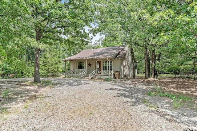 207 Pagosa Ln, Holly Lake Ranch, TX 75765 - view of front of property with a porch and a chimney