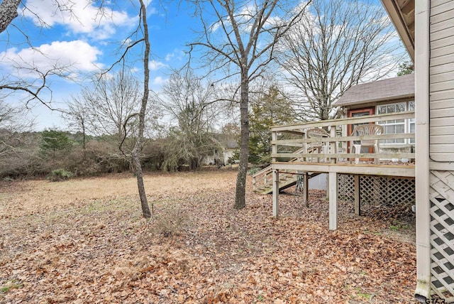 view of yard featuring a deck and stairway