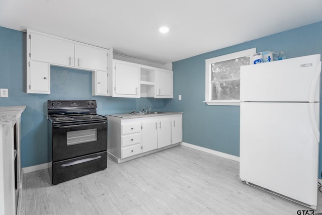 1910 E Lake St, Tyler, TX 75701 - kitchen with freestanding refrigerator, electric range, white cabinets, light wood-type flooring, and light countertops