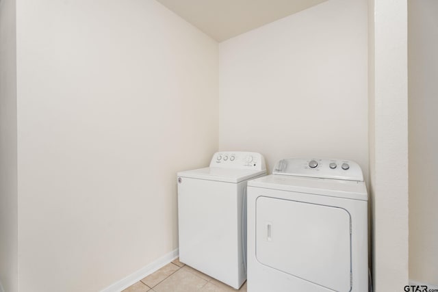1910 E Lake St, Tyler, TX 75701 - laundry room featuring washing machine and dryer and light tile patterned flooring