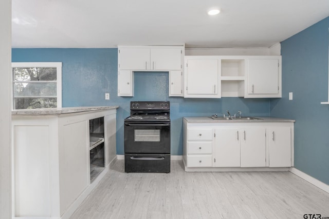 1910 E Lake St, Tyler, TX 75701 - kitchen featuring black electric range oven, white cabinetry, light countertops, and light wood-type flooring