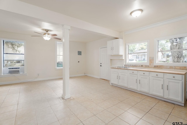 1910 E Lake St, Tyler, TX 75701 - kitchen featuring cooling unit, white cabinets, light countertops, a ceiling fan, and open floor plan