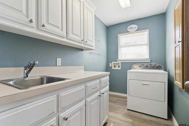 904 Van Winkle Cir, Athens, TX 75751 - laundry room featuring washer / clothes dryer, cabinet space, light wood-style floors, and baseboards