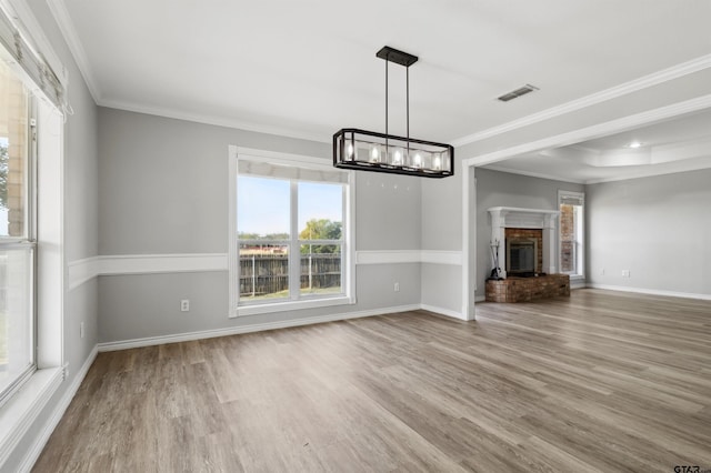 904 Van Winkle Cir, Athens, TX 75751 - unfurnished living room with ornamental molding, wood finished floors, healthy amount of natural light, baseboards, and a chandelier