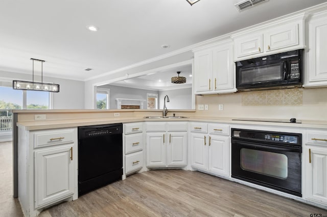 904 Van Winkle Cir, Athens, TX 75751 - kitchen featuring black appliances, a sink, light countertops, light wood-type flooring, and a peninsula
