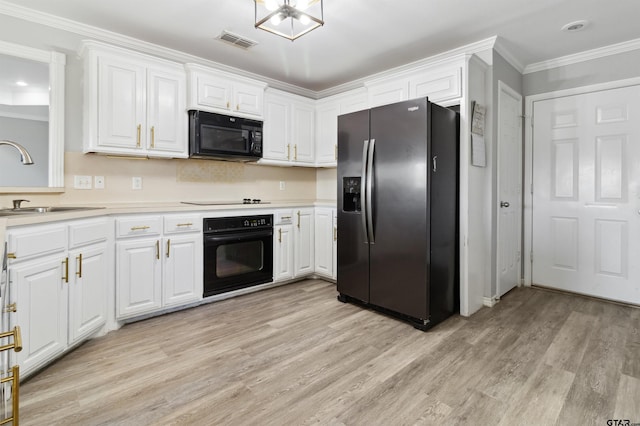 904 Van Winkle Cir, Athens, TX 75751 - kitchen with black appliances, a sink, light wood-style floors, ornamental molding, and white cabinetry