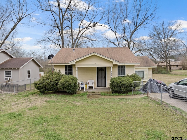 bungalow featuring cooling unit, fence, a front lawn, and a porch