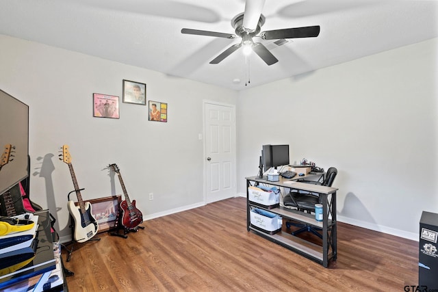 office space with baseboards, a ceiling fan, wood finished floors, and visible vents