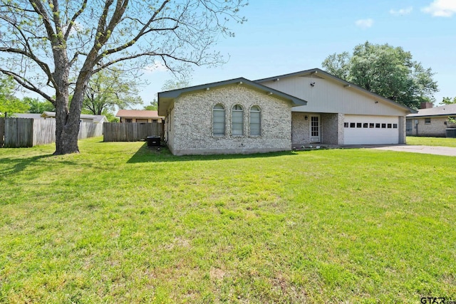 single story home featuring fence, an attached garage, driveway, and a front yard