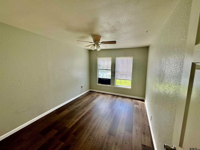 unfurnished room with ceiling fan, a textured ceiling, and dark hardwood / wood-style floors