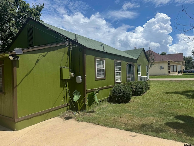 view of side of property with a yard