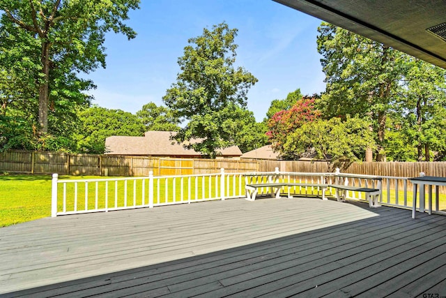 wooden deck with a lawn