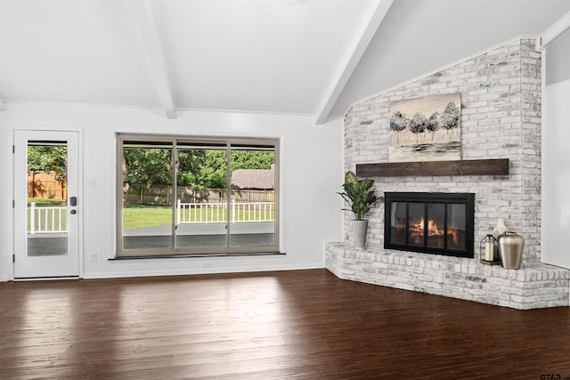 unfurnished living room with a fireplace, vaulted ceiling with beams, and dark hardwood / wood-style floors