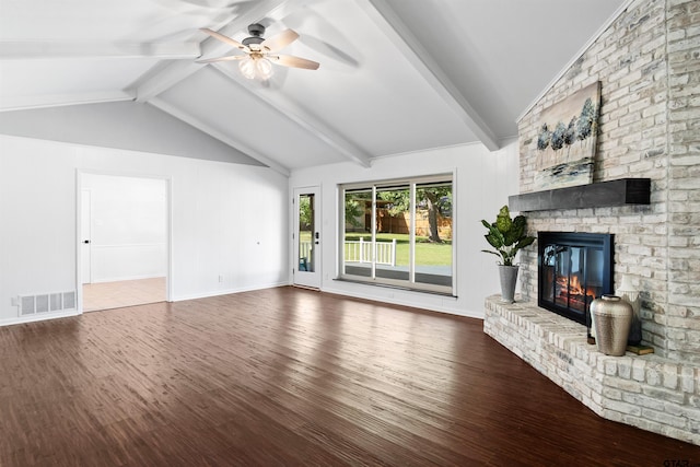 unfurnished living room featuring hardwood / wood-style floors, a fireplace, lofted ceiling with beams, and ceiling fan