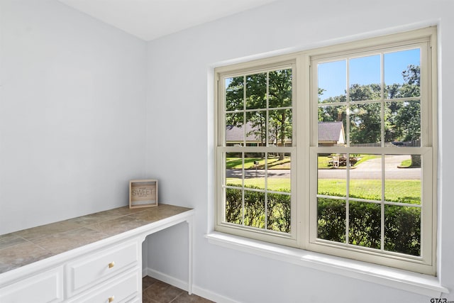 doorway to outside featuring dark tile patterned floors