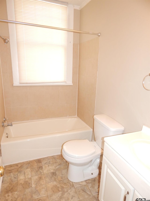 full bathroom featuring vanity, tiled shower / bath combo, toilet, and ornamental molding