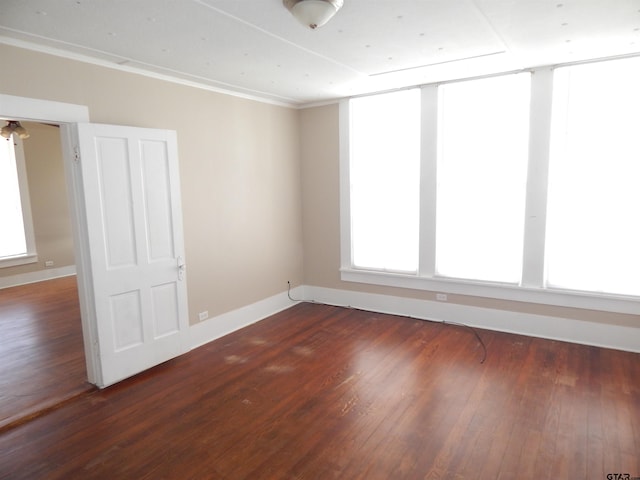 unfurnished room with dark hardwood / wood-style floors and crown molding