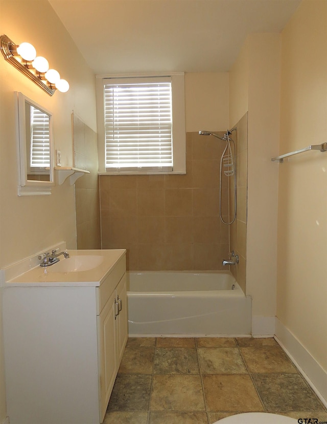 bathroom with vanity and tiled shower / bath