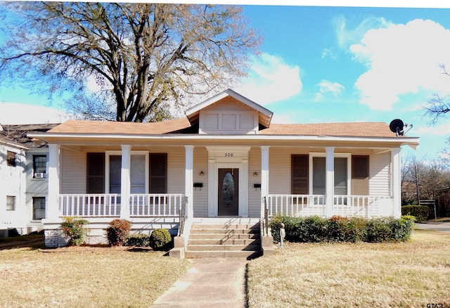 bungalow featuring a front lawn and a porch