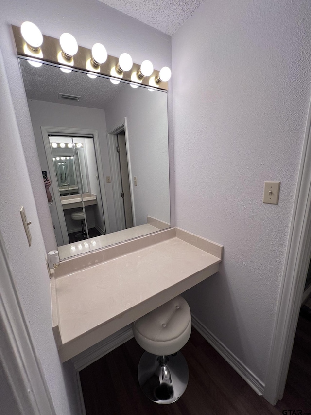 226 Circle Ridge Dr, Gilmer, TX 75645 - bathroom featuring a textured ceiling, wood finished floors, and baseboards