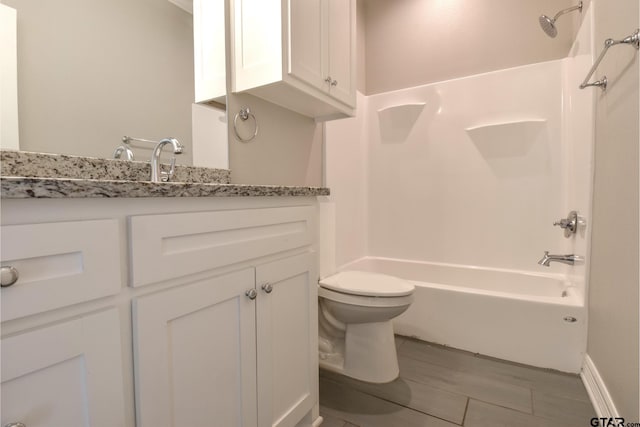 full bathroom with hardwood / wood-style floors, vanity, toilet, and bathing tub / shower combination