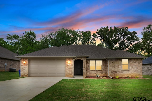 view of front of property featuring a yard and a garage