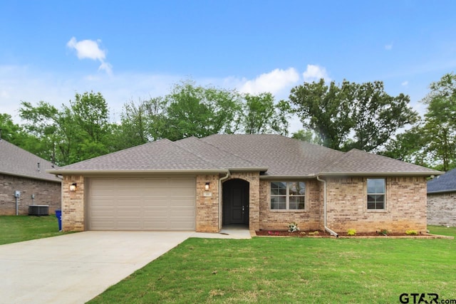 ranch-style house featuring a garage and a front yard