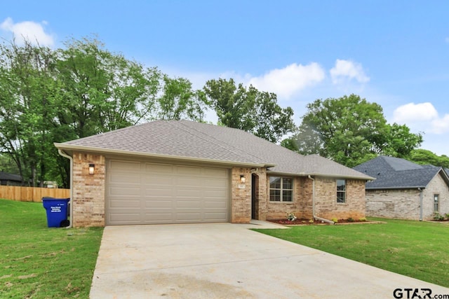 single story home with a garage and a front lawn