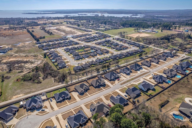 birds eye view of property featuring a water view and a residential view