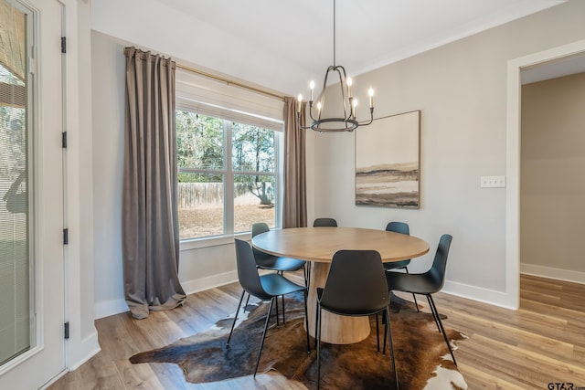 dining room with an inviting chandelier, wood finished floors, and baseboards