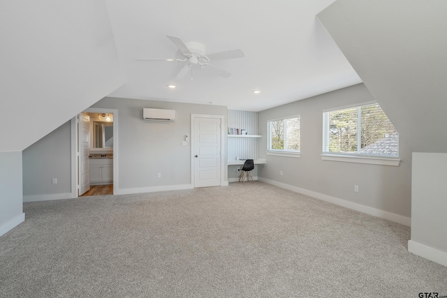 bonus room featuring recessed lighting, baseboards, light colored carpet, and a wall mounted air conditioner