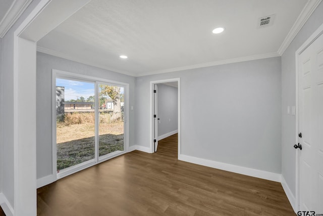 empty room with dark wood-type flooring and ornamental molding