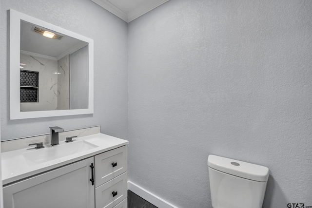 bathroom featuring crown molding, vanity, and toilet