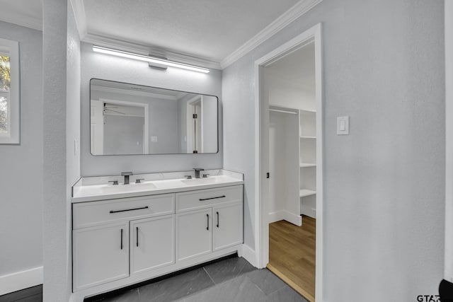 bathroom featuring tile patterned flooring, vanity, and crown molding