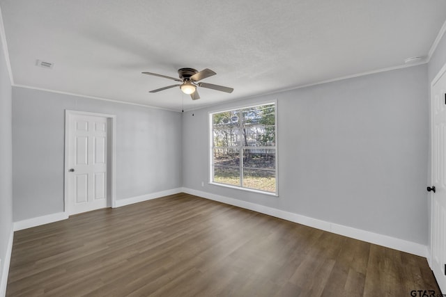 empty room with ornamental molding, dark hardwood / wood-style floors, and ceiling fan