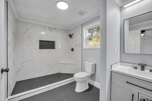 bathroom with crown molding, tiled shower, vanity, and toilet