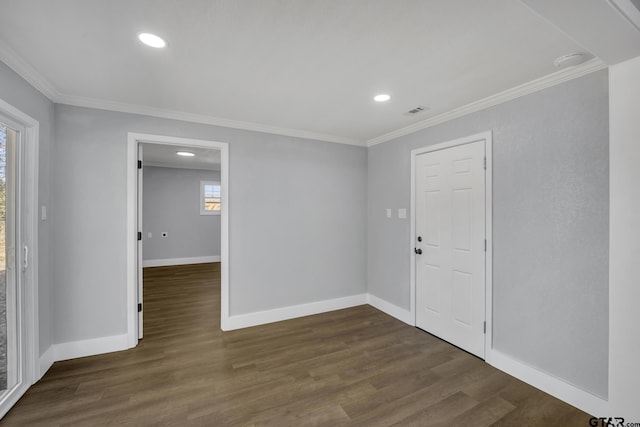 empty room with dark wood-type flooring and ornamental molding