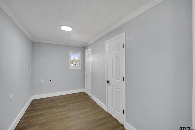 spare room with dark wood-type flooring and ornamental molding