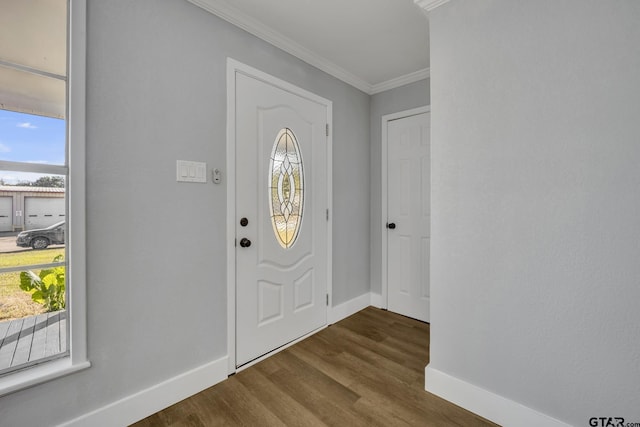 foyer entrance featuring dark hardwood / wood-style flooring and crown molding