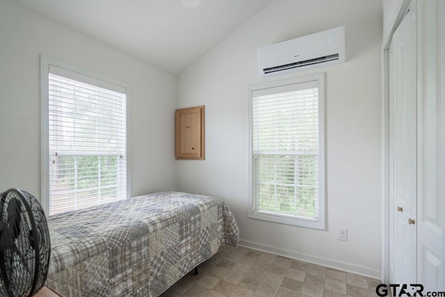 bedroom with baseboards, a wall mounted air conditioner, and vaulted ceiling