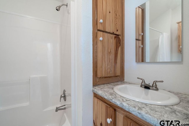 bathroom with shower / tub combo with curtain and vanity