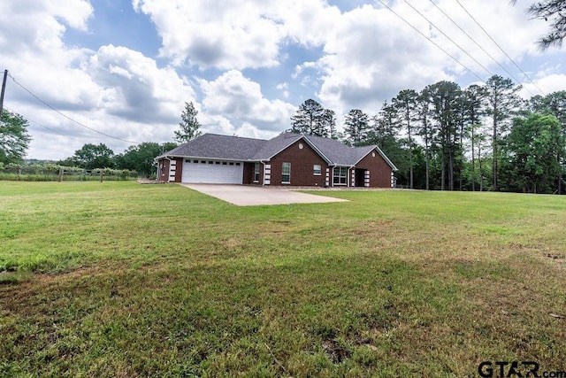 view of front of home with an attached garage, a front lawn, fence, and brick siding