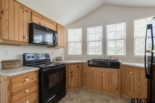 kitchen with a sink, light countertops, black appliances, and lofted ceiling