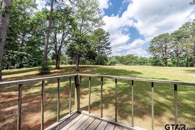 wooden deck with a lawn
