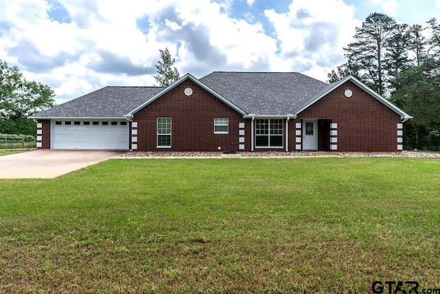 view of front of home with brick siding, an attached garage, driveway, and a front lawn