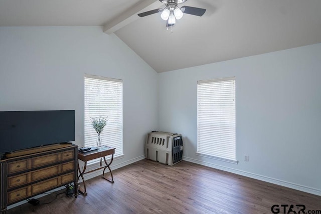 misc room featuring plenty of natural light, a ceiling fan, lofted ceiling with beams, and wood finished floors
